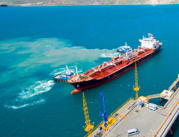 tanker moored to the port using tugs tanker moored to the port using tugs